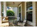 Inviting front porch with seating, perfect for enjoying the outdoors in a cozy and comfortable setting at 3664 Privette Rd, Matthews, NC 28104