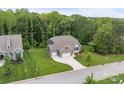 Sprawling property featuring lush greenery, a well-maintained lawn, brick home, and mature trees in a serene neighborhood setting at 3817 Arial Ln # 145, York, SC 29745