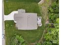 Backyard view of home featuring a deck with lounge area and stone patio with firepit surrounded by lush greenery at 3817 Arial Ln # 145, York, SC 29745