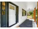 Covered front porch and modern front door of this lovely updated house at 5428 Barnsdale Ln, Mint Hill, NC 28227