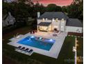 Aerial view of the backyard featuring a large pool, outdoor seating, and manicured lawn at 5806 Bentway Dr, Charlotte, NC 28226
