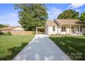 View of the exterior featuring a lengthy driveway with a carport at 6100 Ashcrest Dr, Charlotte, NC 28217