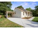 A quaint house boasting a carport and a generous driveway at 6100 Ashcrest Dr, Charlotte, NC 28217