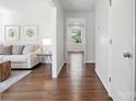 Hallway with hardwood floors and natural light, connecting the living spaces at 6100 Ashcrest Dr, Charlotte, NC 28217