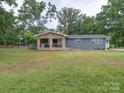 Lovely single-story home boasts a welcoming stone porch and a spacious, green front yard at 6604 Plyler Mill Rd, Monroe, NC 28112
