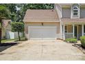 Attached two-car garage with a wide driveway and manicured landscaping at 6640 Autumn Gate Ln, Charlotte, NC 28216