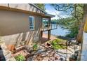 A private backyard area features a brick patio, wrought iron furniture, and stunning water views at 6664 Lake Shore Dr, Hickory, NC 28601