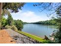 Breathtaking lake view, framed by lush greenery and direct water access at 6664 Lake Shore Dr, Hickory, NC 28601