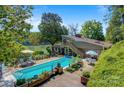 An inviting in-ground pool is surrounded by a wooden deck and mature landscaping at 6664 Lake Shore Dr, Hickory, NC 28601