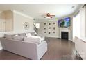 Comfortable living room featuring a fireplace, mounted TV, and stylish decor at 8317 Dallas Bay Rd, Charlotte, NC 28278