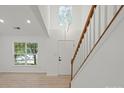 Inviting foyer showcasing an elegant staircase, high ceilings, and natural light at 8347 Fox Swamp Rd, Charlotte, NC 28215