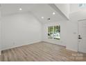 Bright, airy living room with wood floors and a large window offering a pleasant view at 8347 Fox Swamp Rd, Charlotte, NC 28215