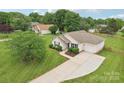 Beautiful aerial view of a well-maintained home, showcasing its large driveway and mature landscaping at 908 Dairy Meadow Ct, Monroe, NC 28110