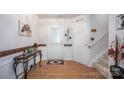 Inviting foyer with wood floors, a glass table, and a staircase at 9359 Hillston Ridge Rd, Huntersville, NC 28078