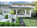 Inviting front porch with classic columns, stylish decor, and professionally landscaped garden beds at 108 Balmoral Dr, Mooresville, NC 28117
