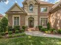 Stunning brick home entrance with elegant landscaping at 10924 Lederer Ave, Charlotte, NC 28277