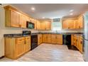 Well-lit kitchen featuring ample wood cabinetry, sleek countertops, and modern appliances at 11861 Nc Hwy 73 E Hwy, Mount Pleasant, NC 28124
