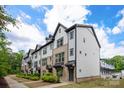 Street view of modern townhomes with brick and gray siding with black trim at 13022 Simoneaux Ln, Charlotte, NC 28277