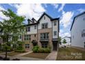 New construction townhome with brick and gray siding with black trim accents at 13022 Simoneaux Ln, Charlotte, NC 28277