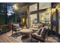 Cozy covered patio with comfortable seating, offering a relaxing outdoor living space and views of the backyard at 131 Sierra Woods Dr, Troutman, NC 28166