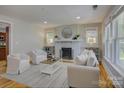 Bright living room featuring a decorative fireplace, hardwood floors, and neutral furniture arrangement at 1324 E 35Th St, Charlotte, NC 28205