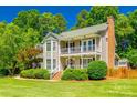 Inviting two-story home featuring a double front porch, brick accents, and a well-manicured lawn at 1355 Woodrun Ct, Rock Hill, SC 29732