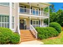 Close-up of the home's entrance with brick steps, white railings, and a charming decorative wreath on the front door at 1355 Woodrun Ct, Rock Hill, SC 29732