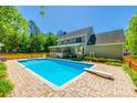 Backyard view of a stunning in-ground pool with diving board, surrounded by a brick patio and wooden fence at 1355 Woodrun Ct, Rock Hill, SC 29732