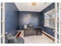 Private office with french doors, a large window, dark blue walls, and a stylish area rug at 15131 Oleander Dr, Charlotte, NC 28278