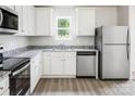 Bright kitchen with stainless steel appliances, granite countertops, and white cabinetry at 1578 Doran Ter, Richburg, SC 29729