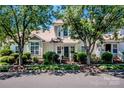 Inviting two-story townhome with manicured lawn and mature trees on a sunny day at 17307 Villanova Rd, Huntersville, NC 28078
