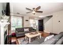 Bright and airy living room featuring hardwood floors, a ceiling fan, and comfortable seating at 17307 Villanova Rd, Huntersville, NC 28078