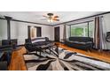 Open-concept living room with hardwood floors, a fireplace, and large windows at 1917 Tom Sadler Rd, Charlotte, NC 28214