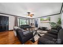 Bright living room with hardwood floors, dark trim, and large windows at 1917 Tom Sadler Rd, Charlotte, NC 28214