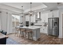 Beautiful kitchen island with marble countertop, modern light fixtures, and barstool seating, perfect for entertaining at 1945 Hendricks St, Rock Hill, SC 29732