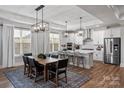 Bright open concept kitchen with stainless steel appliances, marble countertop island, and a breakfast bar at 1945 Hendricks St, Rock Hill, SC 29732