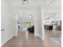 Open-concept living space with wood floors, fireplace, recessed lighting, and a view to the kitchen at 210 Dorothy Dr, China Grove, NC 28023