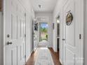 Bright hallway with wood floors, leading to the front door and a glimpse of the outdoors at 234 Ascot Run Way, Fort Mill, SC 29715