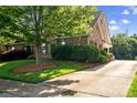 Well-maintained yard with lush green grass, mature trees, and manicured bushes surrounding this lovely home at 286 Liverpool Rd, Rock Hill, SC 29730