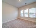 Bright bedroom with neutral carpet, a large window, and fresh paint at 3069 Founding Fathers Dr, Gastonia, NC 28056