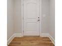 Hallway showing light wood look floors, white baseboards, door and an electrical outlet at 3069 Founding Fathers Dr, Gastonia, NC 28056