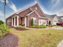 Beautiful brick home with a covered porch, American flag, and well-maintained lawn at 3089 Founding Fathers Dr, Gastonia, NC 28056