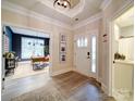 Inviting foyer with wood floors, neutral walls, and doorway to home office at 3089 Founding Fathers Dr, Gastonia, NC 28056