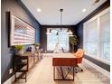 Stylish home office with dark blue walls, ample natural light, and modern furnishings at 3089 Founding Fathers Dr, Gastonia, NC 28056