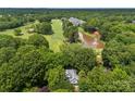 Breathtaking aerial view of the property, showcasing its proximity to the golf course and a serene lake at 3932 Rounding Run Rd, Charlotte, NC 28277