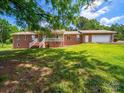 Charming brick home with lush lawn, front porch and ample parking at 40278 Nc 740 Hwy, New London, NC 28127