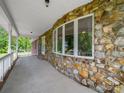 Spacious porch featuring a stone facade and views of the property at 40278 Nc 740 Hwy, New London, NC 28127