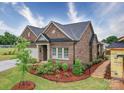 Beautiful exterior view of brick home showcasing landscaping and well-maintained surroundings at 405 Newstyle Way, Gastonia, NC 28056