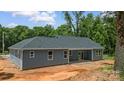 Back of home featuring gray siding and white trim, windows and sliding glass door at 415 Dogwood Ln, Statesville, NC 28625