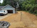 View of the home's driveway and garage, with the yard newly mulched with straw at 415 Dogwood Ln, Statesville, NC 28625